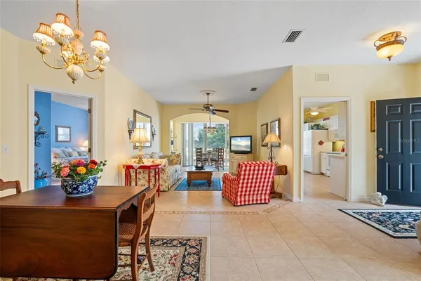a living room with furniture and a mirror