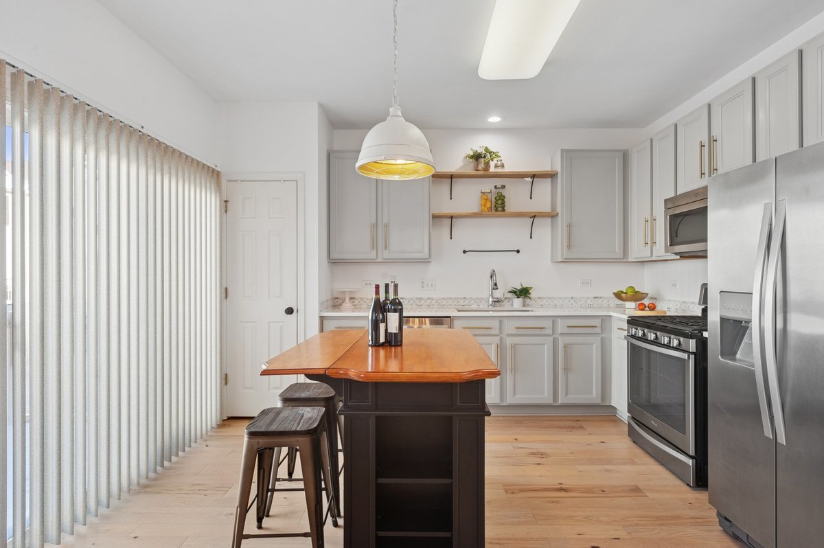 152 Jackson Street Gilberts, IL 60136 - Photo 13 of 32 a kitchen with stainless steel appliances granite countertop a sink a stove and refrigerator