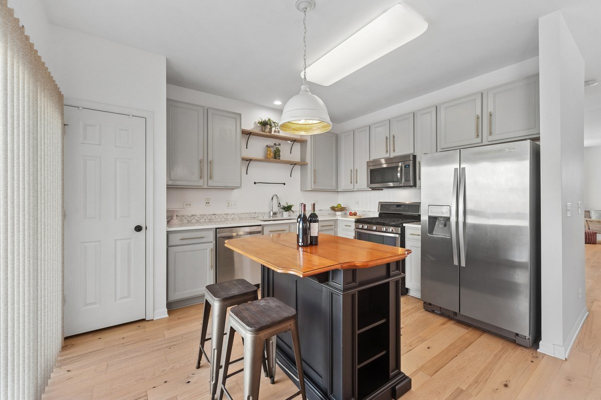 152 Jackson Street Gilberts, IL 60136 - Photo 14 of 32 a kitchen with stainless steel appliances granite countertop a refrigerator a sink a stove a microwave and island