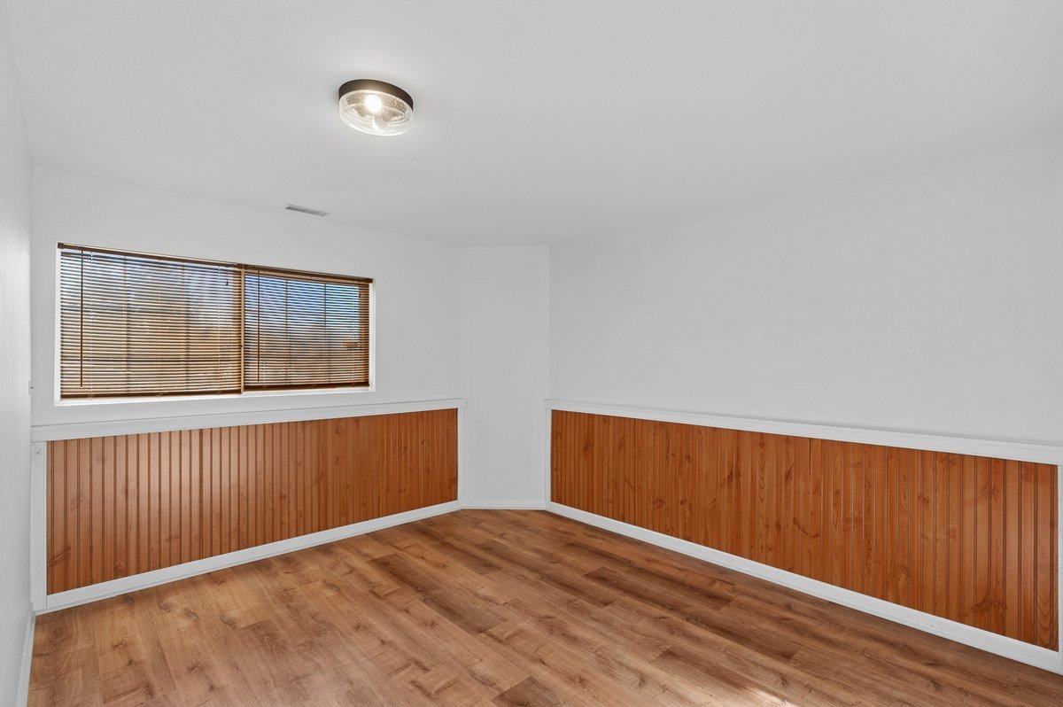 152 Jackson Street Gilberts, IL 60136 - Photo 17 of 32 a view of an empty room with wooden floor and a window