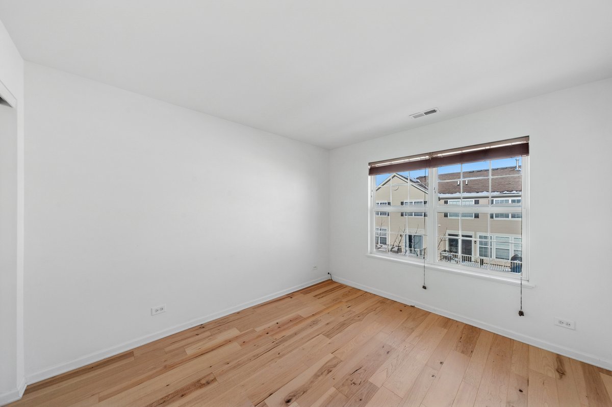 152 Jackson Street Gilberts, IL 60136 - Photo 24 of 32 an empty room with wooden floor and windows