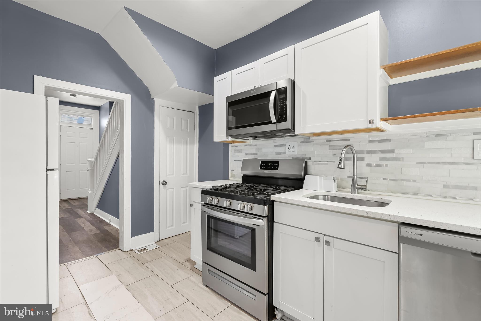 3534 Overview Road Baltimore, MD 21215 - Photo 15 of 28 a kitchen with stainless steel appliances granite countertop a sink stove and microwave