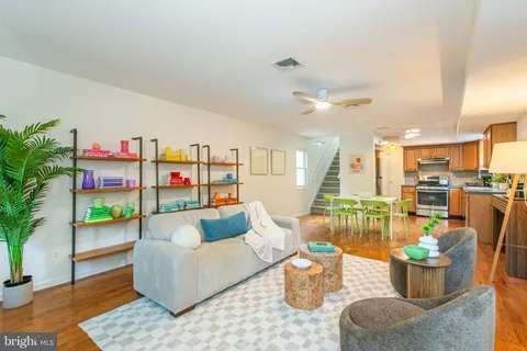 a living room with furniture and a potted plant