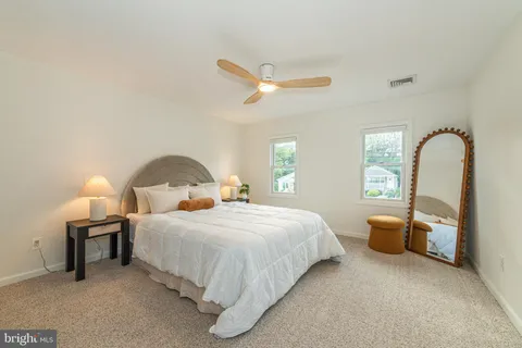 a bedroom with a bed wooden floor and window