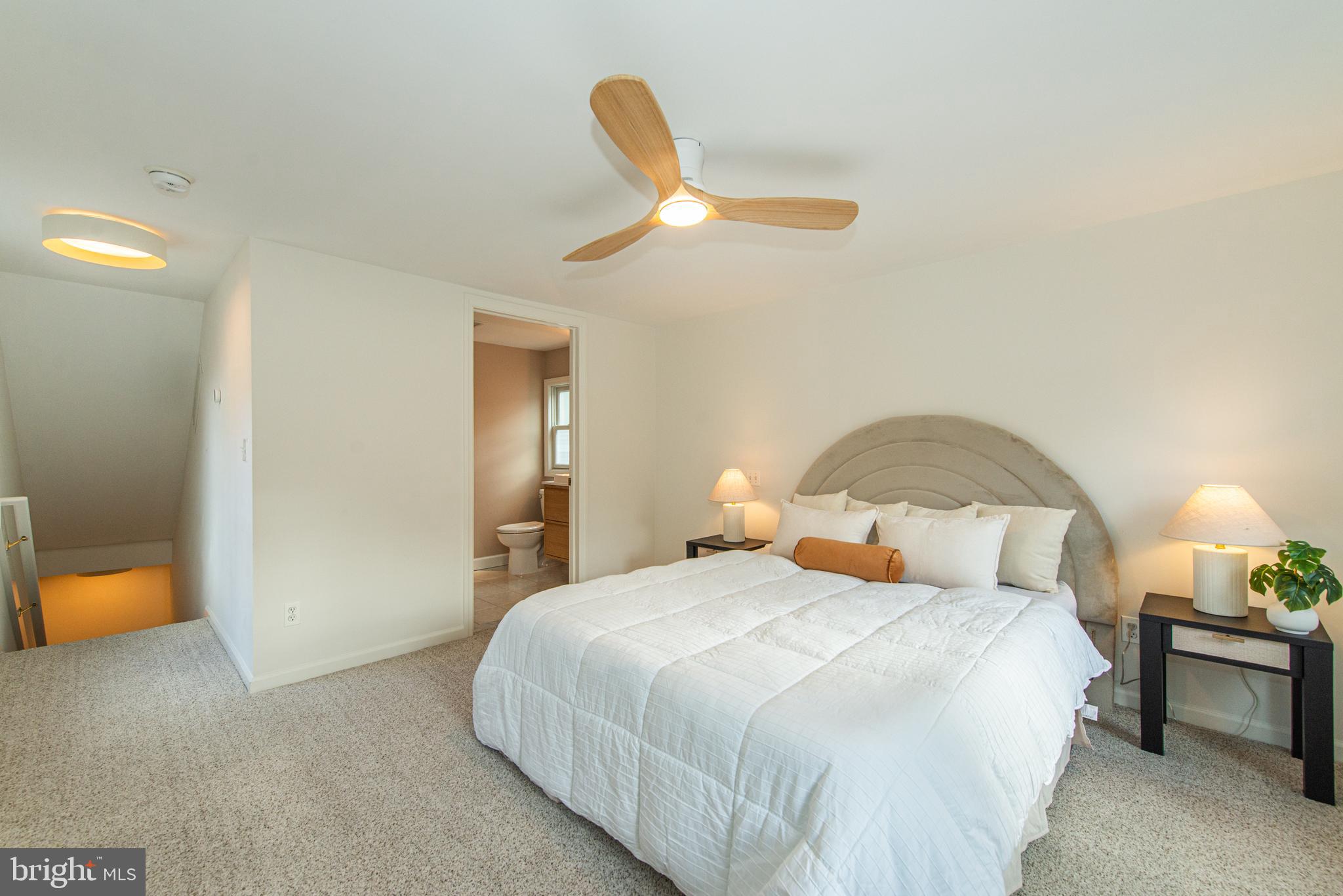 229 South Main Street Pennington, NJ 08534 - Photo 20 of 36 a bedroom with a bed and a chandelier