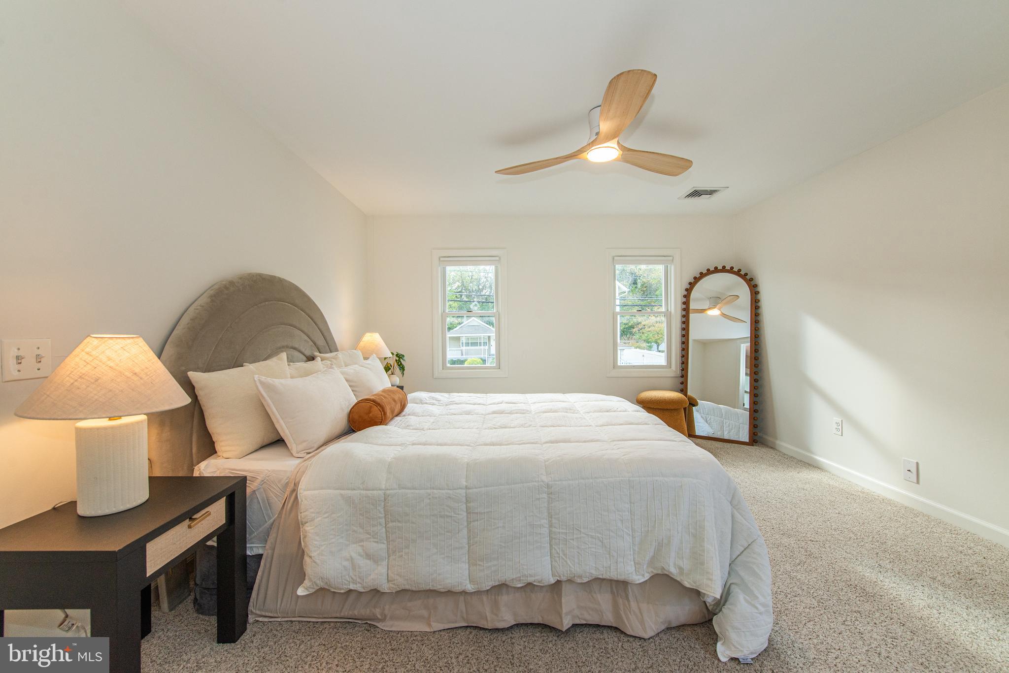 229 South Main Street Pennington, NJ 08534 - Photo 21 of 36 a bedroom with a bed and a large mirror