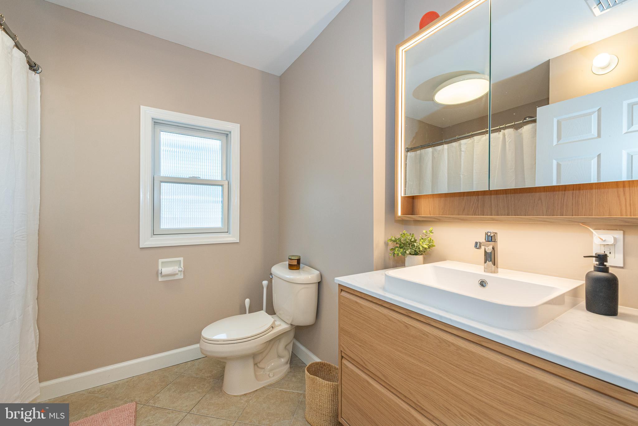 229 South Main Street Pennington, NJ 08534 - Photo 27 of 36 a bathroom with a sink a toilet and a mirror