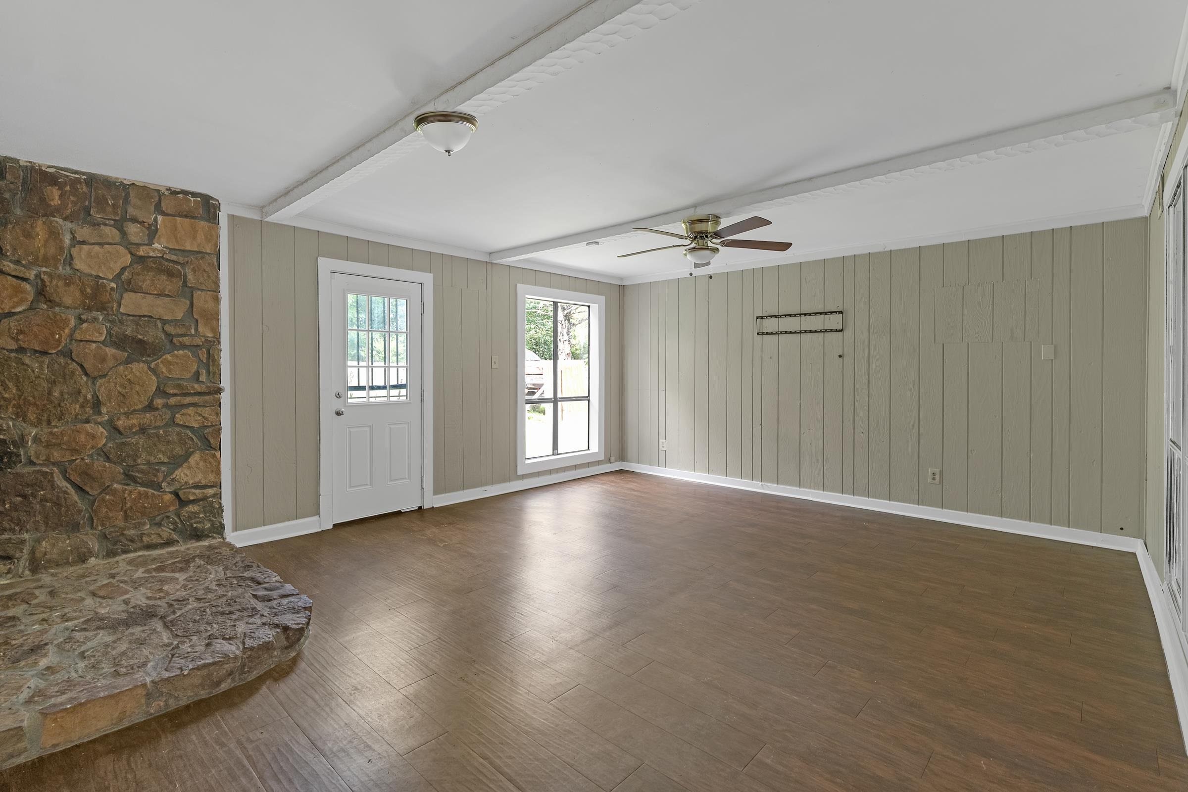 6128 Raintree Drive Memphis, TN 38115 - Photo 12 of 30 a view of an empty room with glass door and wooden floor