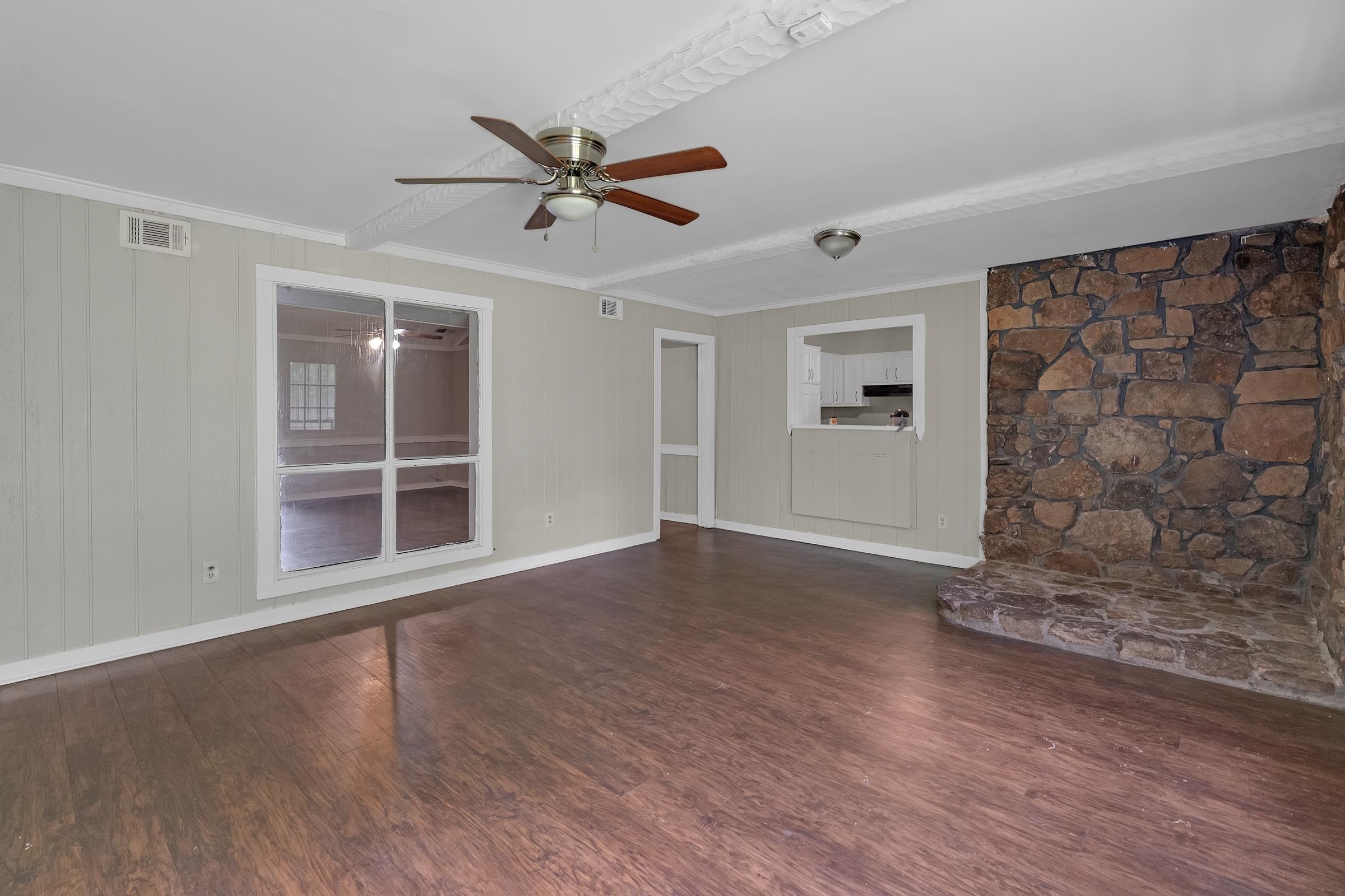 6128 Raintree Drive Memphis, TN 38115 - Photo 14 of 30 a view of empty room with wooden floor and fan