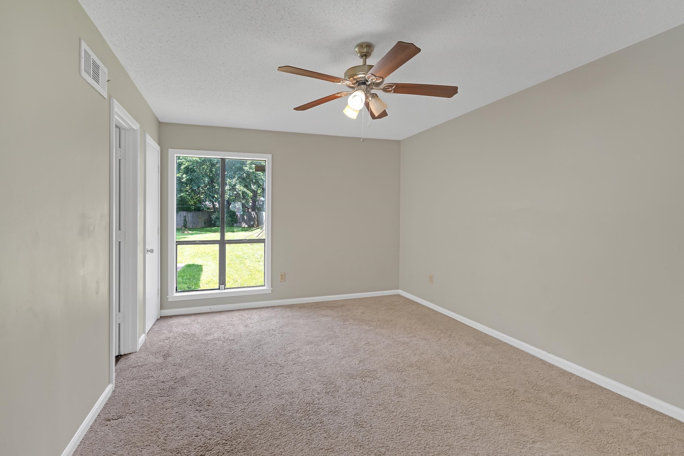 6128 Raintree Drive Memphis, TN 38115 - Photo 20 of 30 an empty room with windows and fan