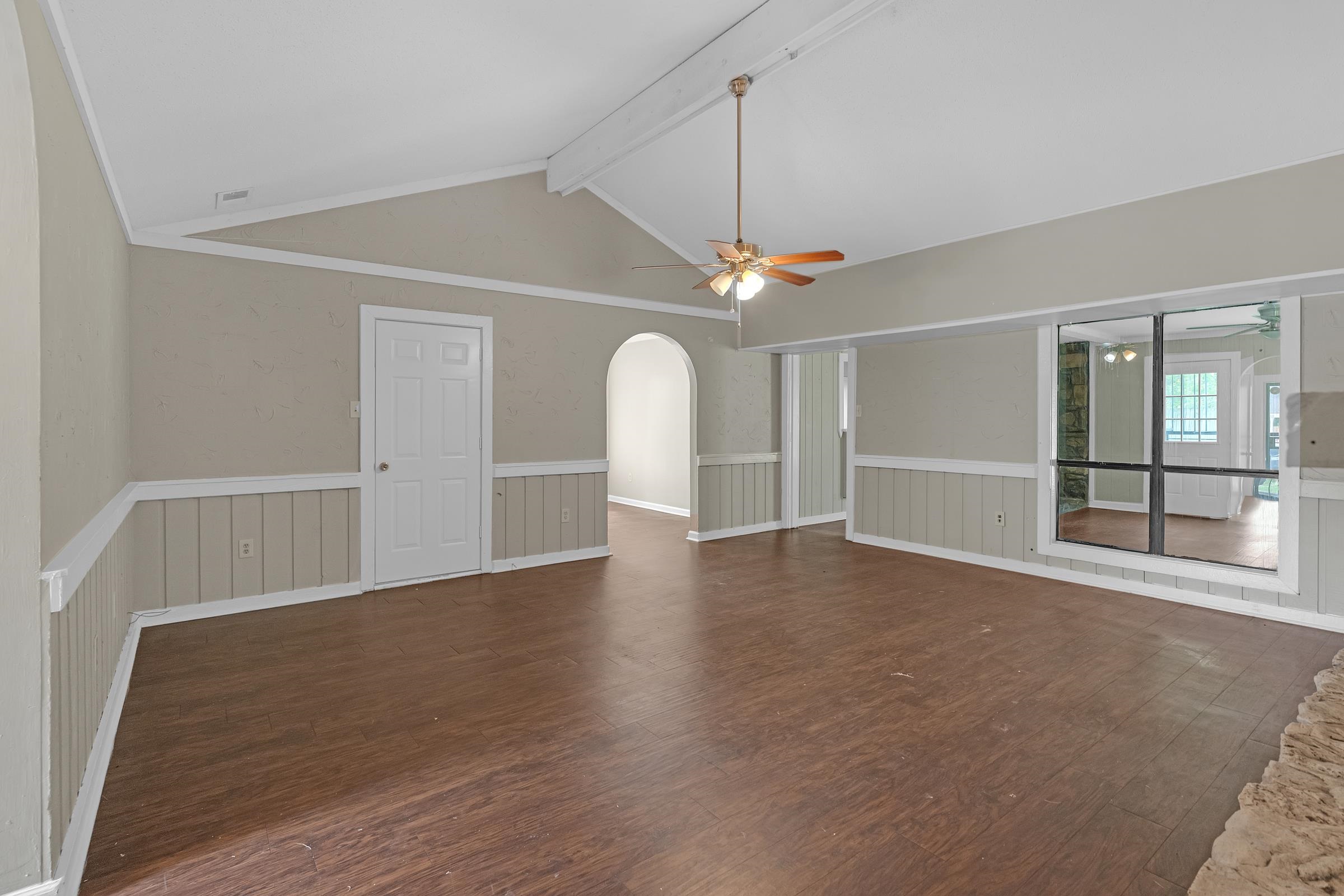 6128 Raintree Drive Memphis, TN 38115 - Photo 3 of 30 an empty room with wooden floor fan and window