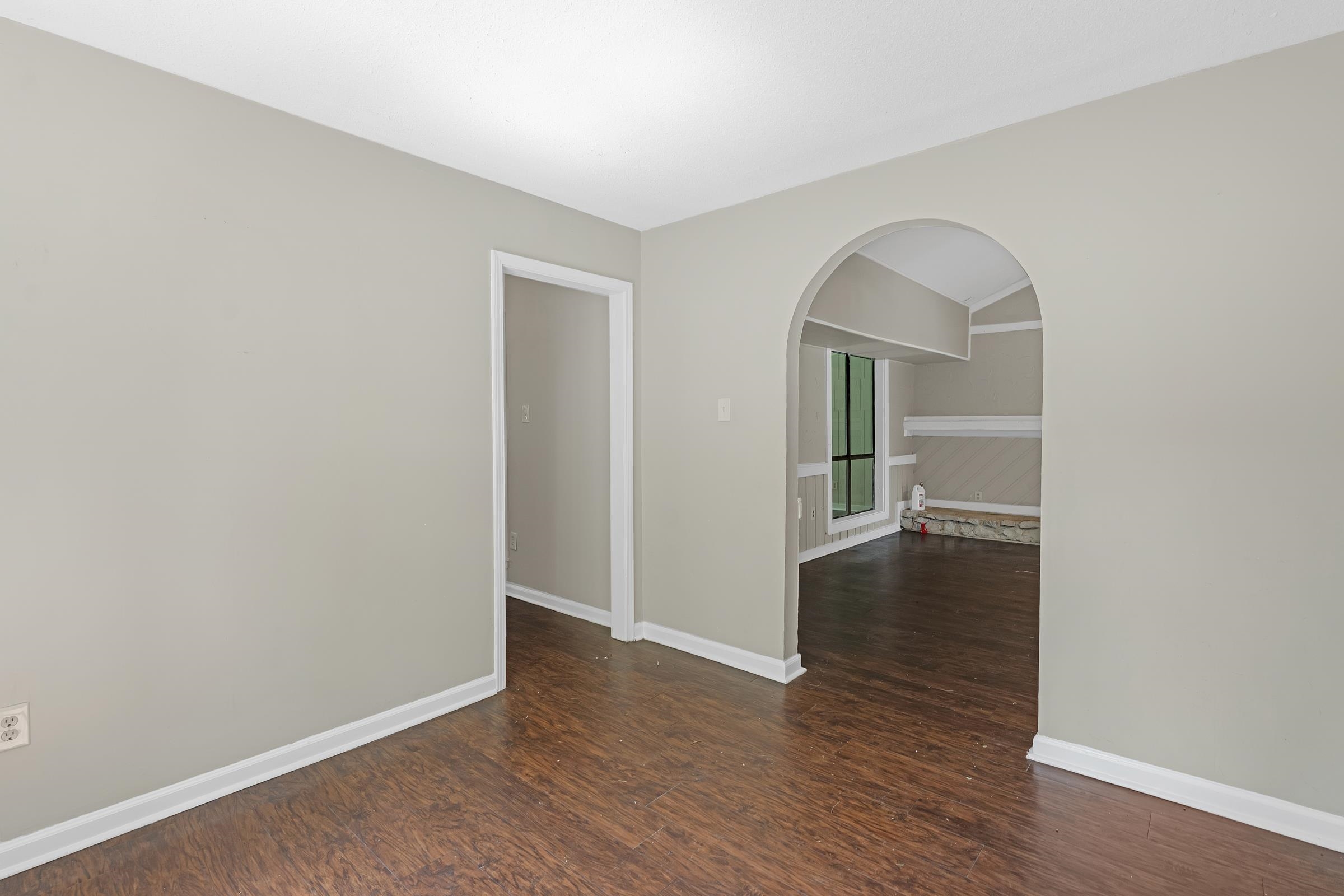 6128 Raintree Drive Memphis, TN 38115 - Photo 8 of 30 an empty room with wooden floor and mirror
