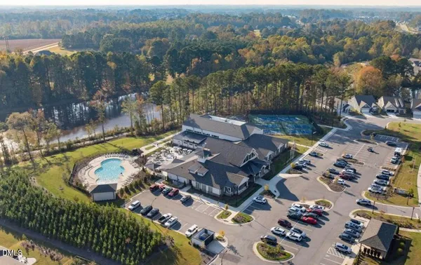 an aerial view of a house with a mountain