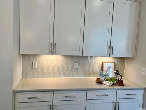 a kitchen with stainless steel appliances white cabinets and a stove