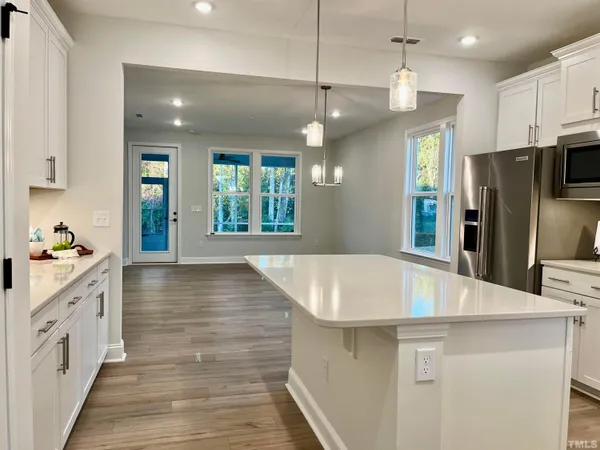 a kitchen with stainless steel appliances a refrigerator and a stove