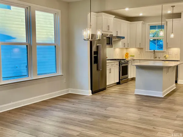 a kitchen with stainless steel appliances granite countertop a refrigerator and a sink