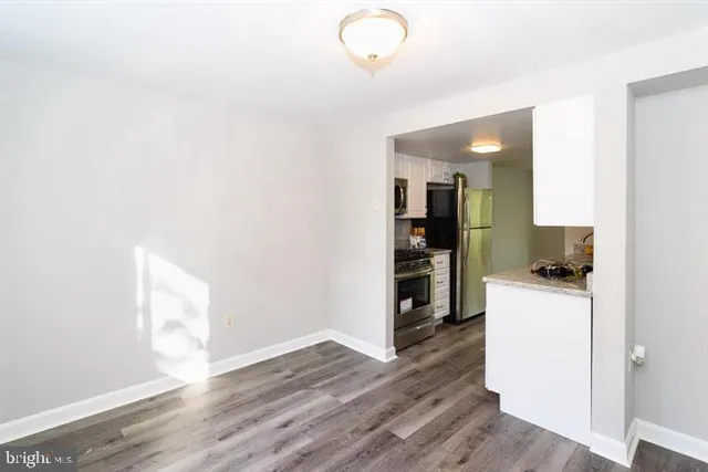 a kitchen with a refrigerator and a stove top oven