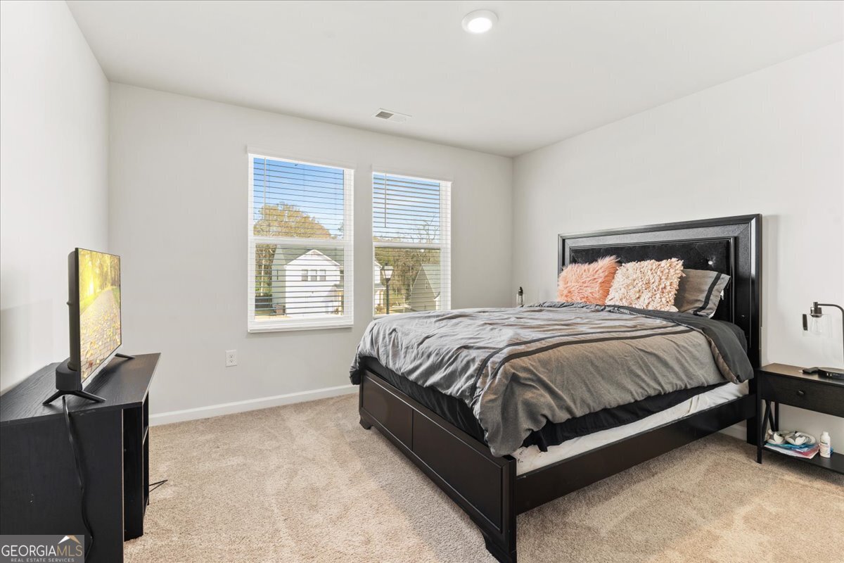 104 Red Barn Court Perry, GA 31069 - Photo 24 of 31 a spacious bedroom with a bed and a window