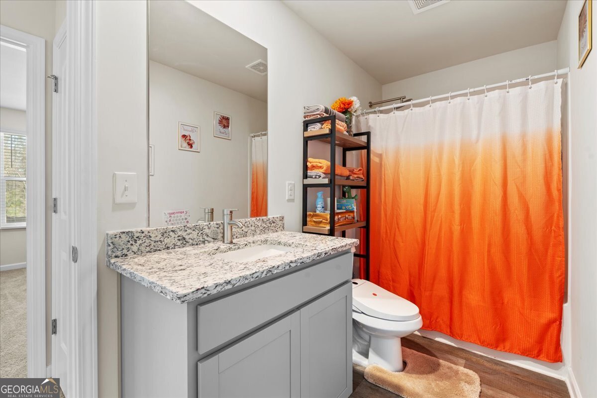 104 Red Barn Court Perry, GA 31069 - Photo 26 of 31 a bathroom with a granite countertop sink toilet and shower