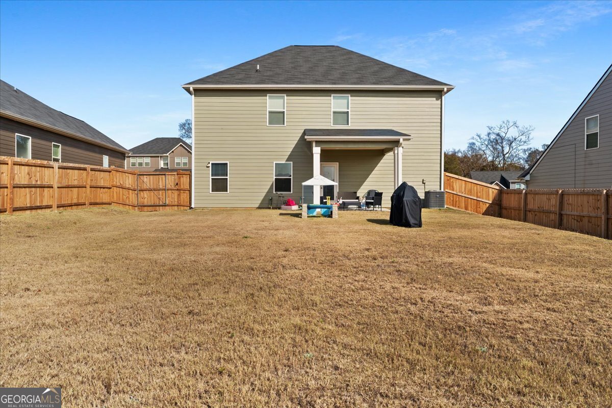 104 Red Barn Court Perry, GA 31069 - Photo 29 of 31 a view of a house with large space and a car park in front of it