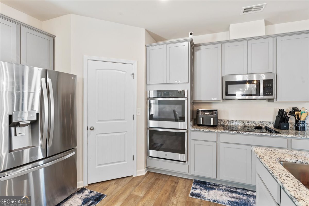 104 Red Barn Court Perry, GA 31069 - Photo 6 of 31 a kitchen with stainless steel appliances a refrigerator sink and microwave