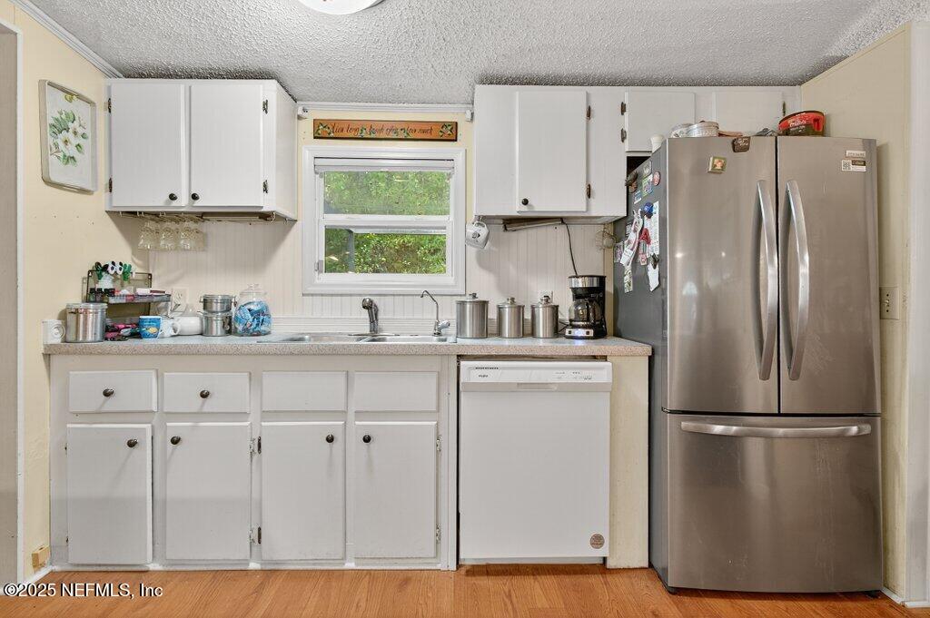 695 Carlin Road Satsuma, FL 32189 - Photo 12 of 53 a kitchen with stainless steel appliances a refrigerator sink and cabinets
