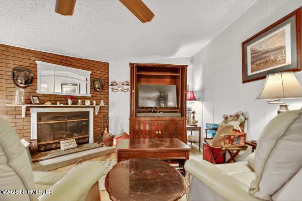 695 Carlin Road Satsuma, FL 32189 - Photo 16 of 53 a living room with furniture and a fireplace