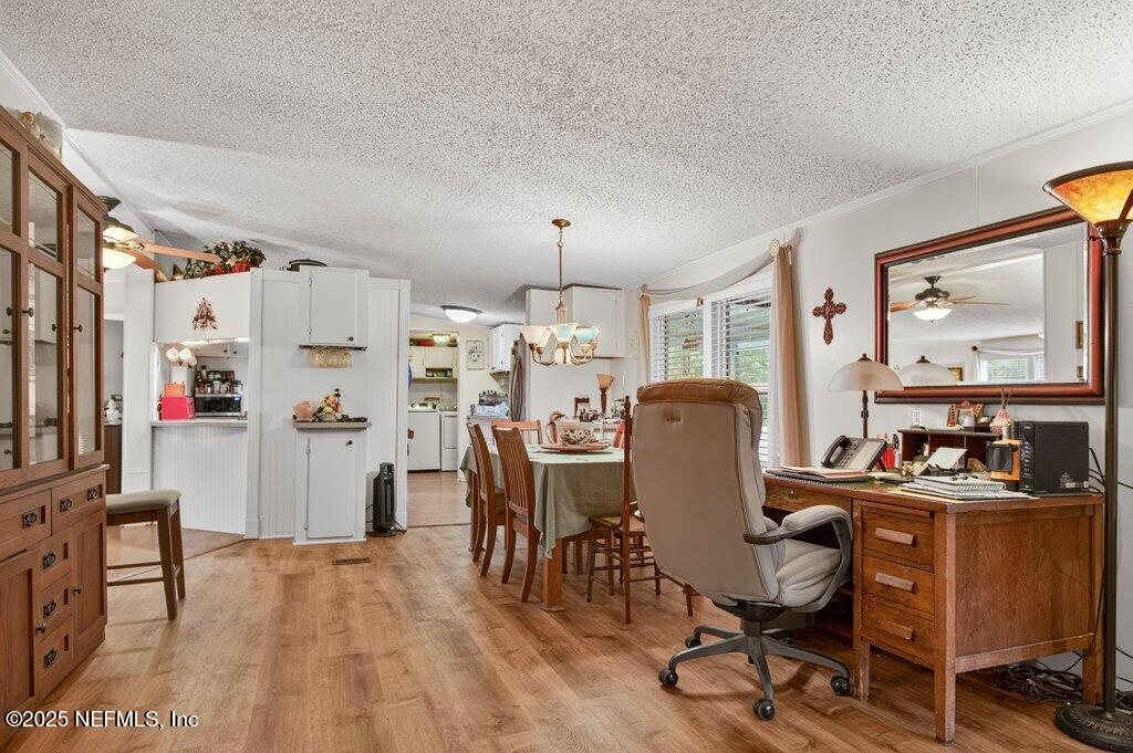 695 Carlin Road Satsuma, FL 32189 - Photo 17 of 53 a view of a dining room with furniture window and wooden floor