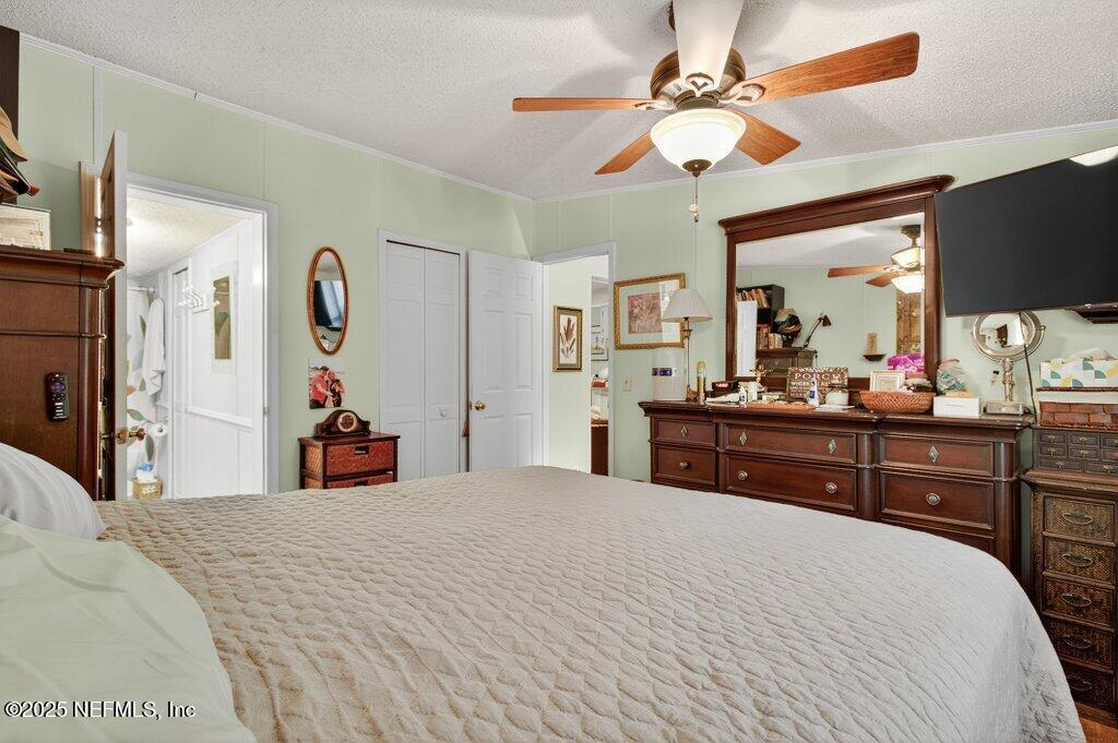 695 Carlin Road Satsuma, FL 32189 - Photo 18 of 53 a bedroom with a bed and a chandelier