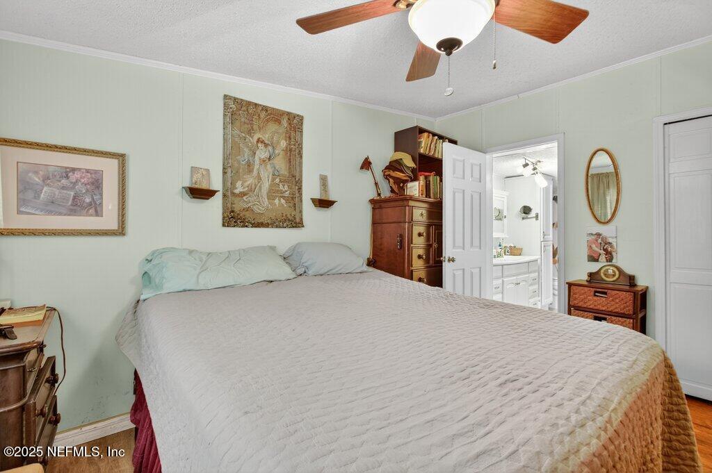 695 Carlin Road Satsuma, FL 32189 - Photo 19 of 53 a bedroom with a bed and a chandelier