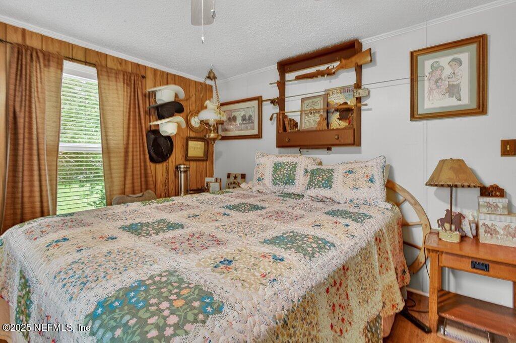695 Carlin Road Satsuma, FL 32189 - Photo 23 of 53 a bedroom with a bed and a flat screen tv