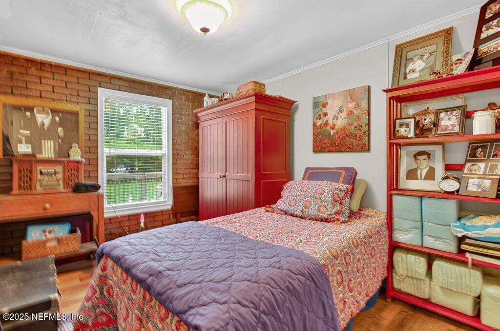 695 Carlin Road Satsuma, FL 32189 - Photo 25 of 53 a bedroom with a bed a dresser next to a window