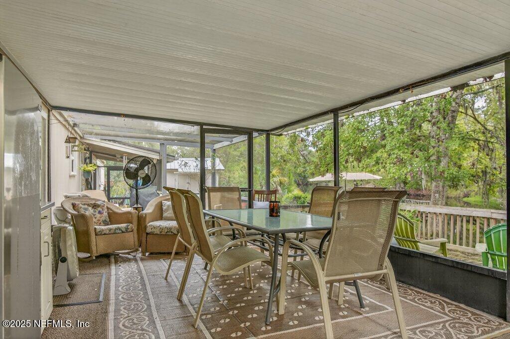 695 Carlin Road Satsuma, FL 32189 - Photo 28 of 53 a view of a dining room with furniture window and outside view