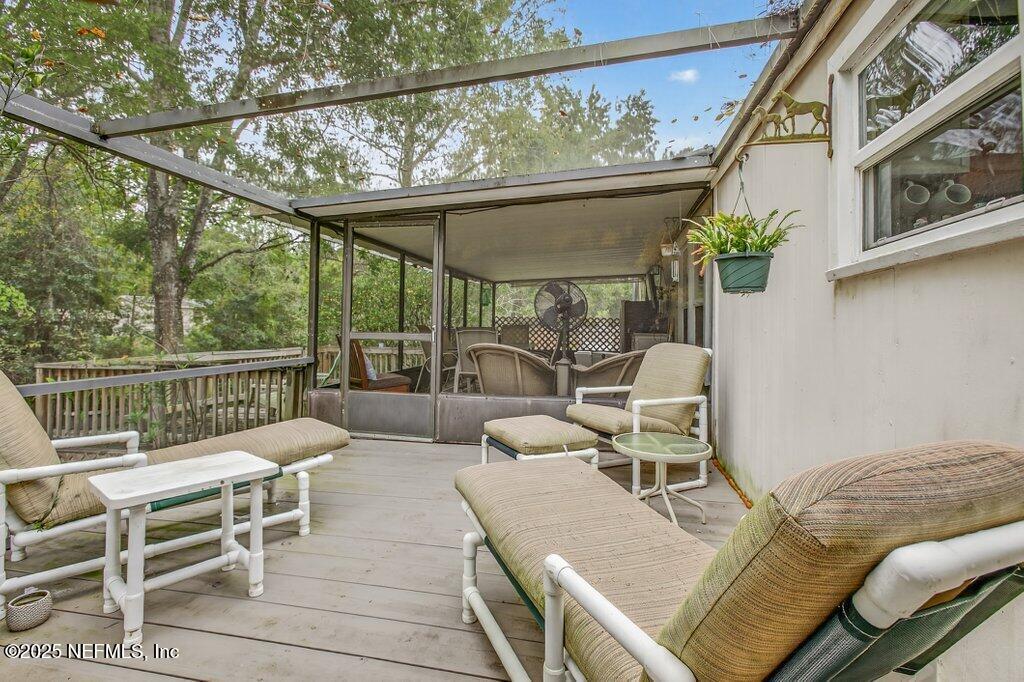 695 Carlin Road Satsuma, FL 32189 - Photo 31 of 53 a balcony with furniture and a potted plant
