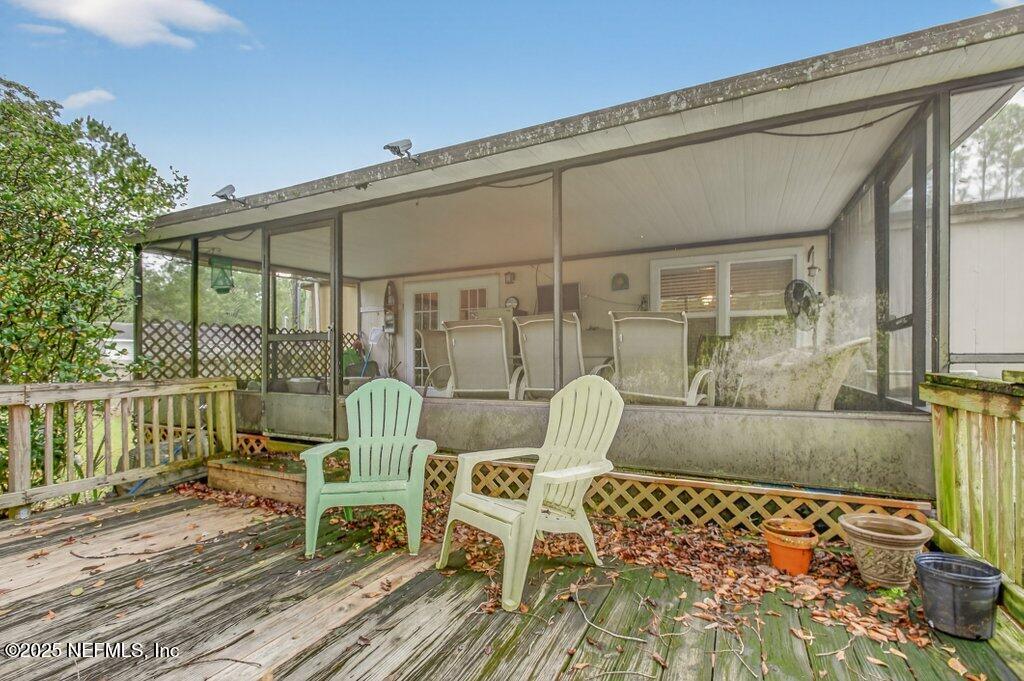 695 Carlin Road Satsuma, FL 32189 - Photo 33 of 53 a view of a patio with table and chairs and wooden floor