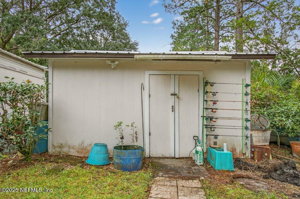 695 Carlin Road Satsuma, FL 32189 - Photo 36 of 53 a side view of a house with potted plants