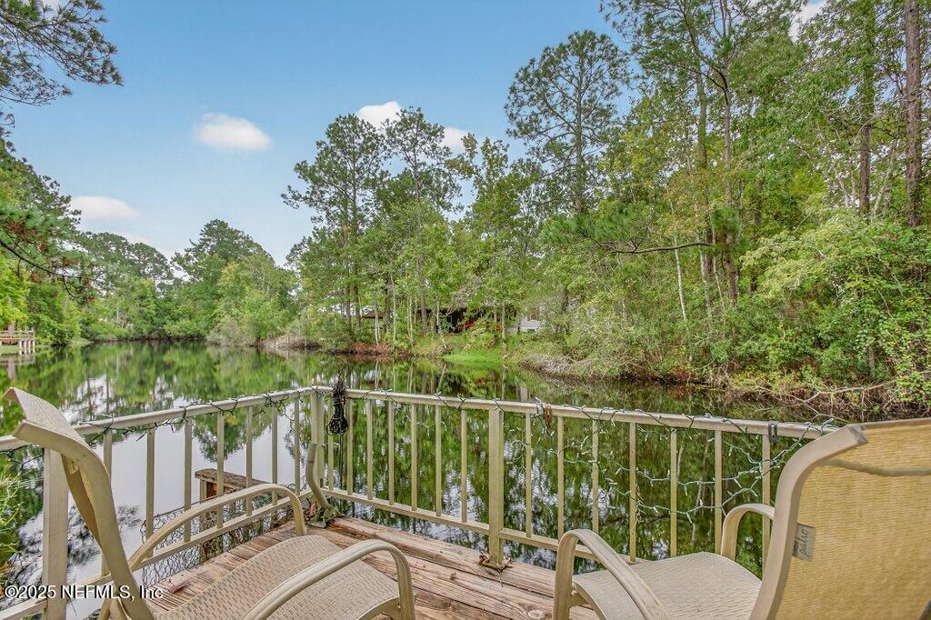695 Carlin Road Satsuma, FL 32189 - Photo 38 of 53 a view of a balcony with floor to ceiling window and wooden fence