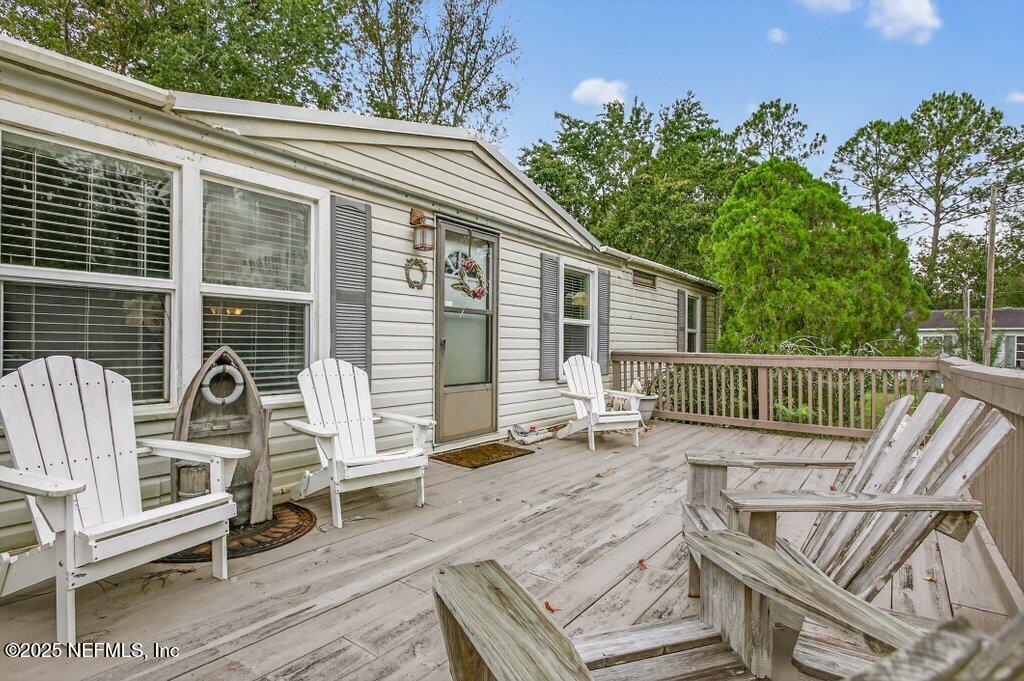 695 Carlin Road Satsuma, FL 32189 - Photo 7 of 53 a view of a chair and tables in the balcony