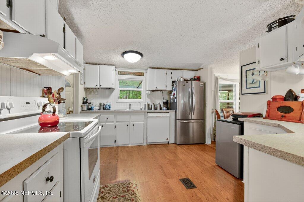 695 Carlin Road Satsuma, FL 32189 - Photo 10 of 53 a kitchen with a sink cabinets and stainless steel appliances
