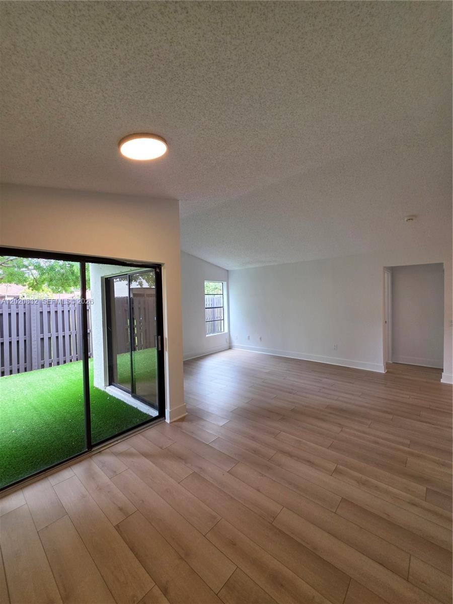 15240 Southwest 45th Terrace, Unit 54F Miami, FL 33185 - Photo 12 of 48 a view of empty room with wooden floor and fan