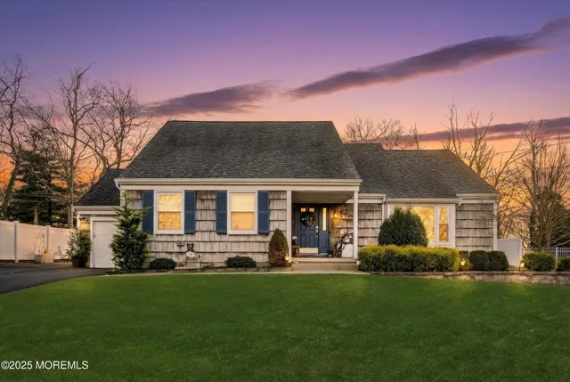 a front view of house with yard and green space