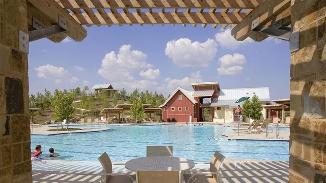 an aerial view of a house with swimming pool outdoor seating and yard