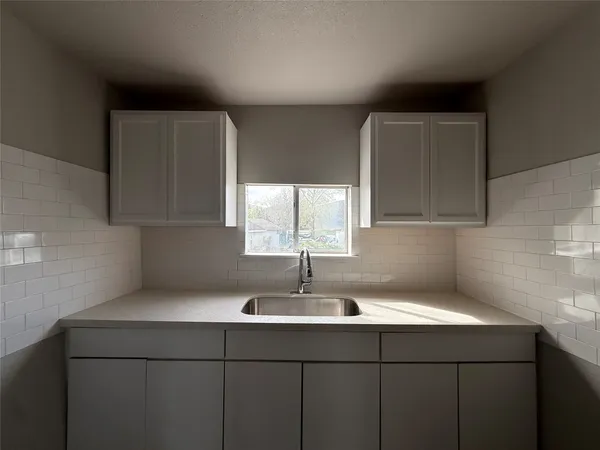 a kitchen with a sink and cabinets