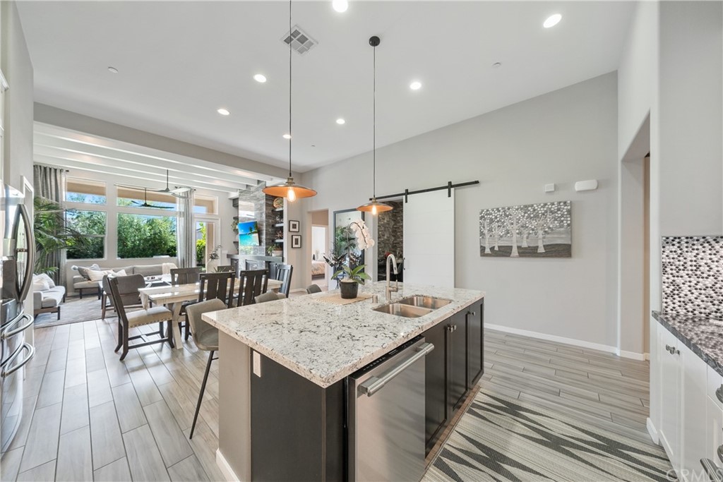 35162 Ladybug Lane Murrieta, CA 92563 - Photo 13 of 58 a kitchen with a table chairs and wooden floor