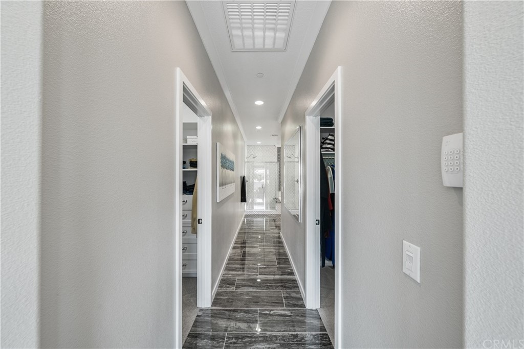 35162 Ladybug Lane Murrieta, CA 92563 - Photo 23 of 58 a view of a hallway with wooden floor and a bathroom