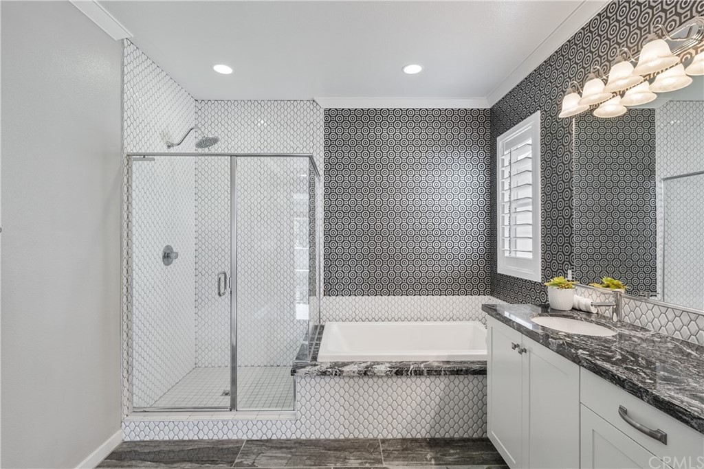 35162 Ladybug Lane Murrieta, CA 92563 - Photo 27 of 58 a spacious bathroom with a granite countertop sink a mirror and a bathtub