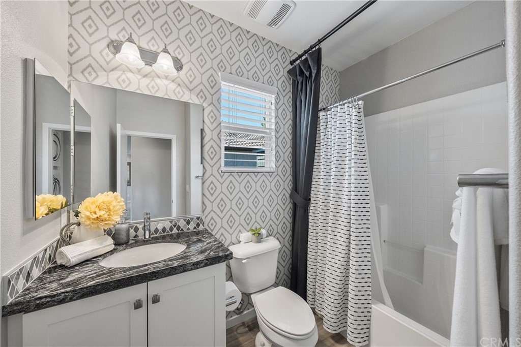 35162 Ladybug Lane Murrieta, CA 92563 - Photo 30 of 58 a bathroom with a granite countertop sink a toilet and shower