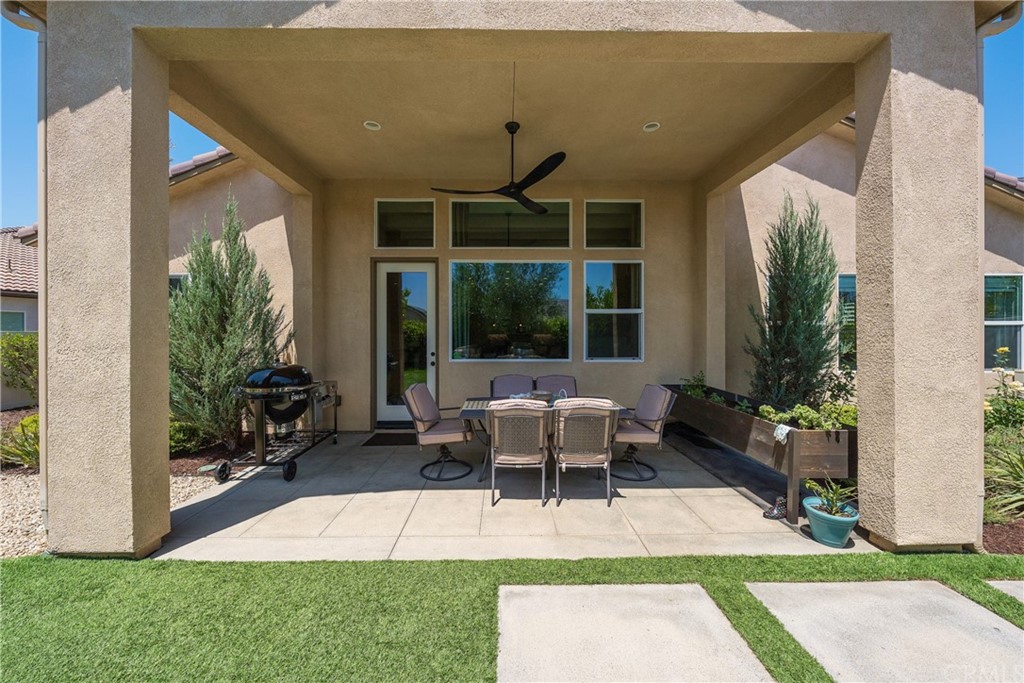 35162 Ladybug Lane Murrieta, CA 92563 - Photo 43 of 58 a view of a patio with table and chairs potted plants and floor to ceiling window