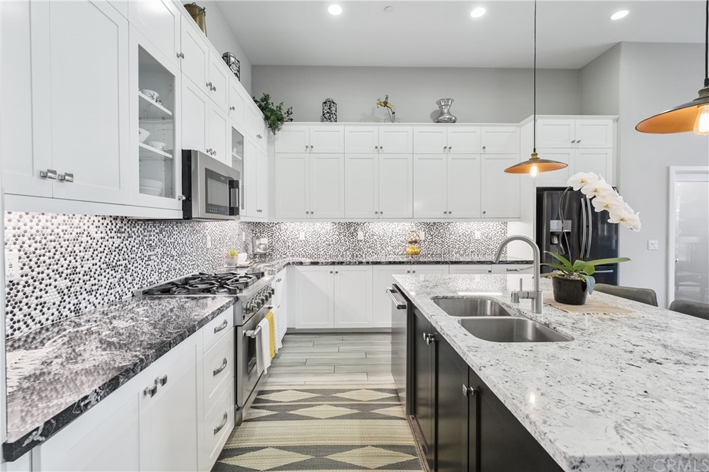 35162 Ladybug Lane Murrieta, CA 92563 - Photo 10 of 58 a kitchen with stainless steel appliances granite countertop a sink a stove and a wooden floors
