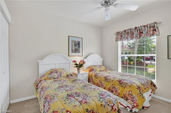 a bedroom with two beds and a window